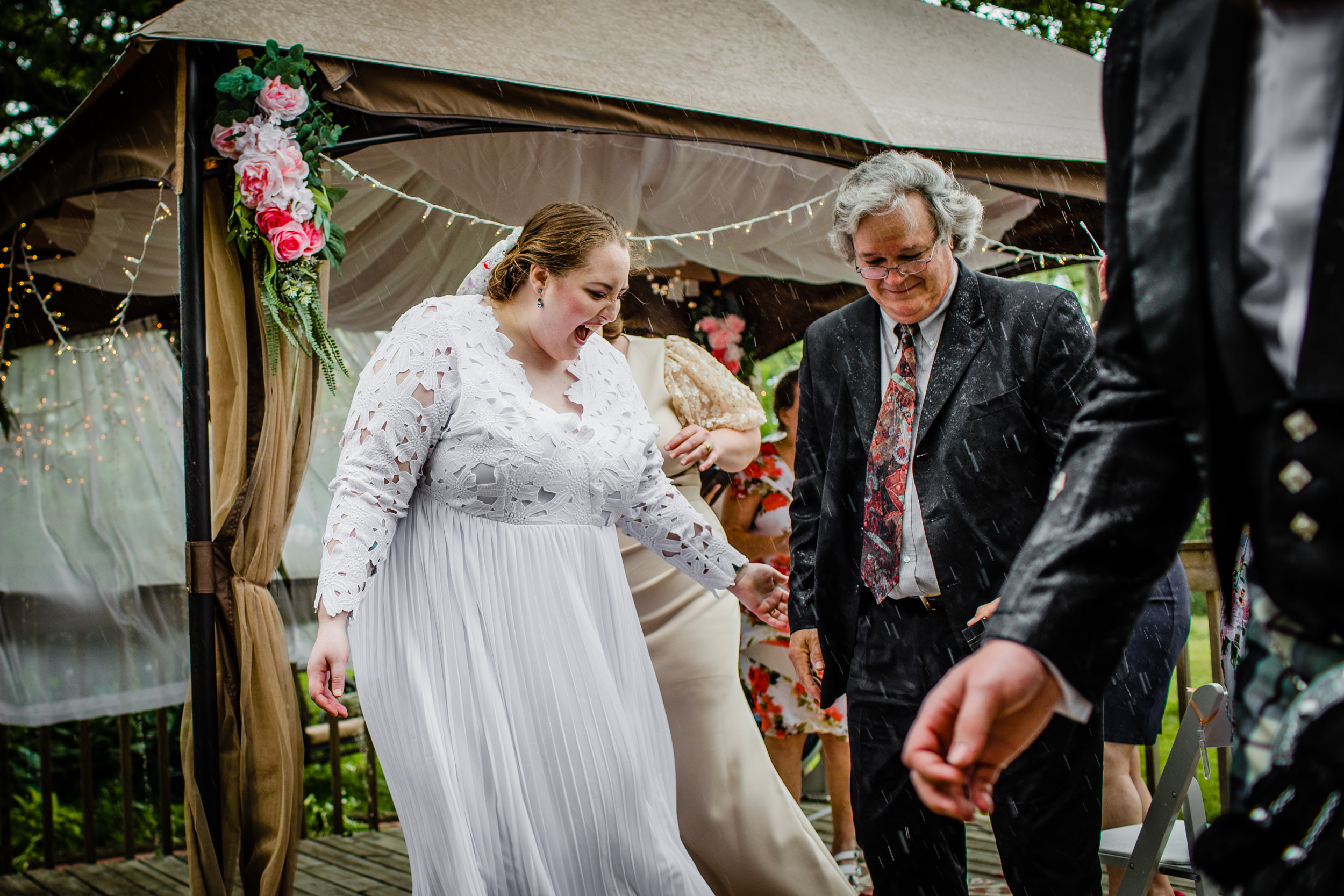 Guests run out of the rain at a backyard wedding in New Lenox, Illinois.