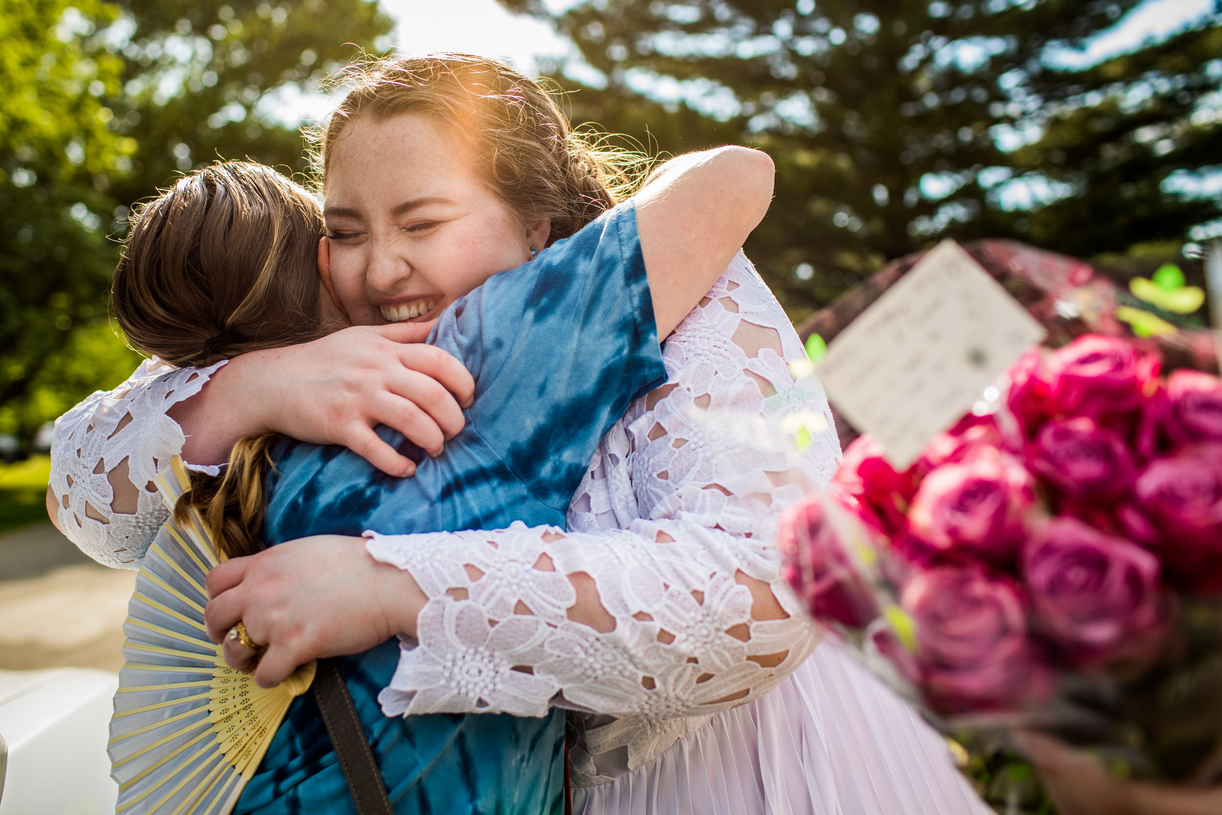 A bride hugs a friend at a backyard wedding in New Lenox, Illinois.